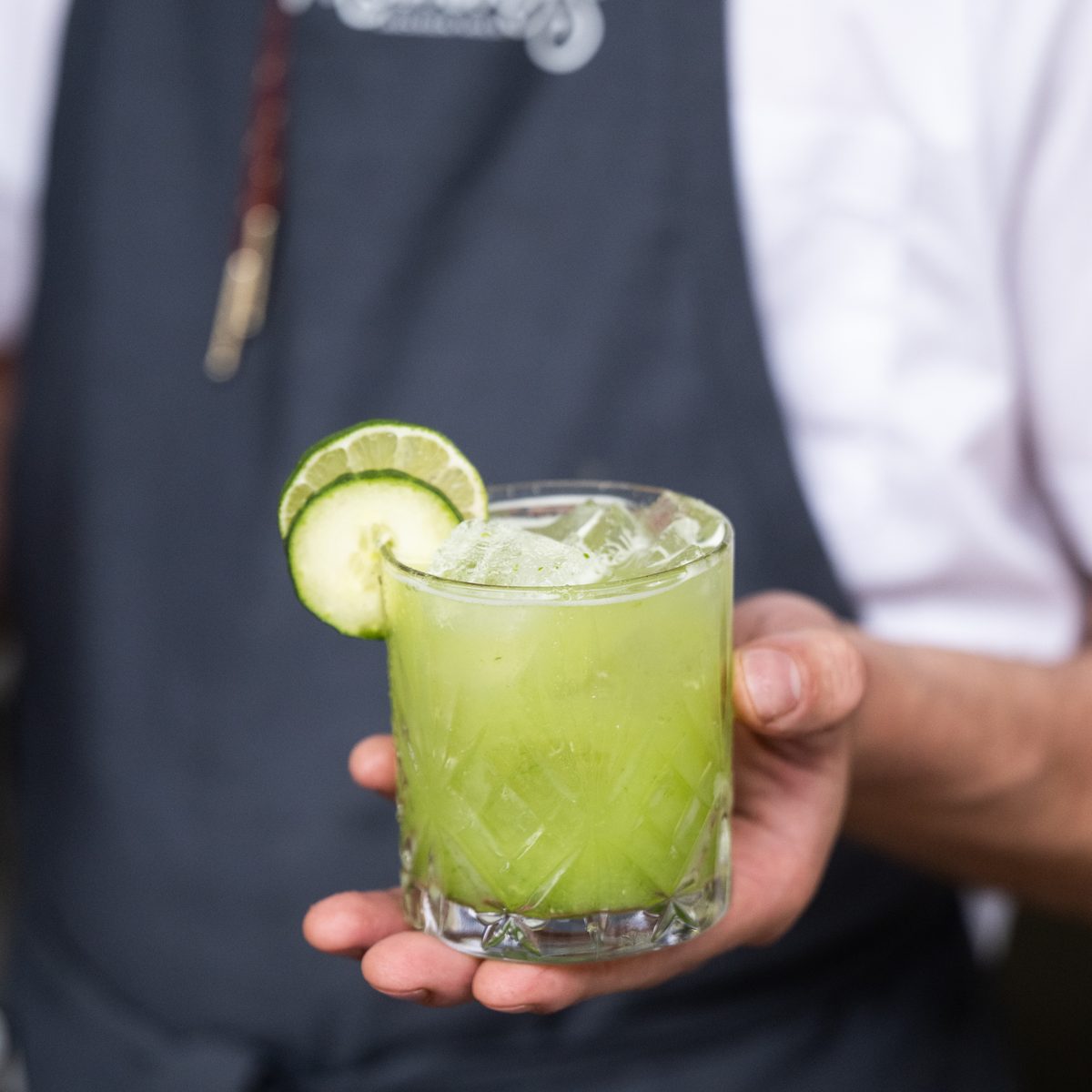 Provisions chef holding a cucumber lime cocktail for a bachelorette dinner