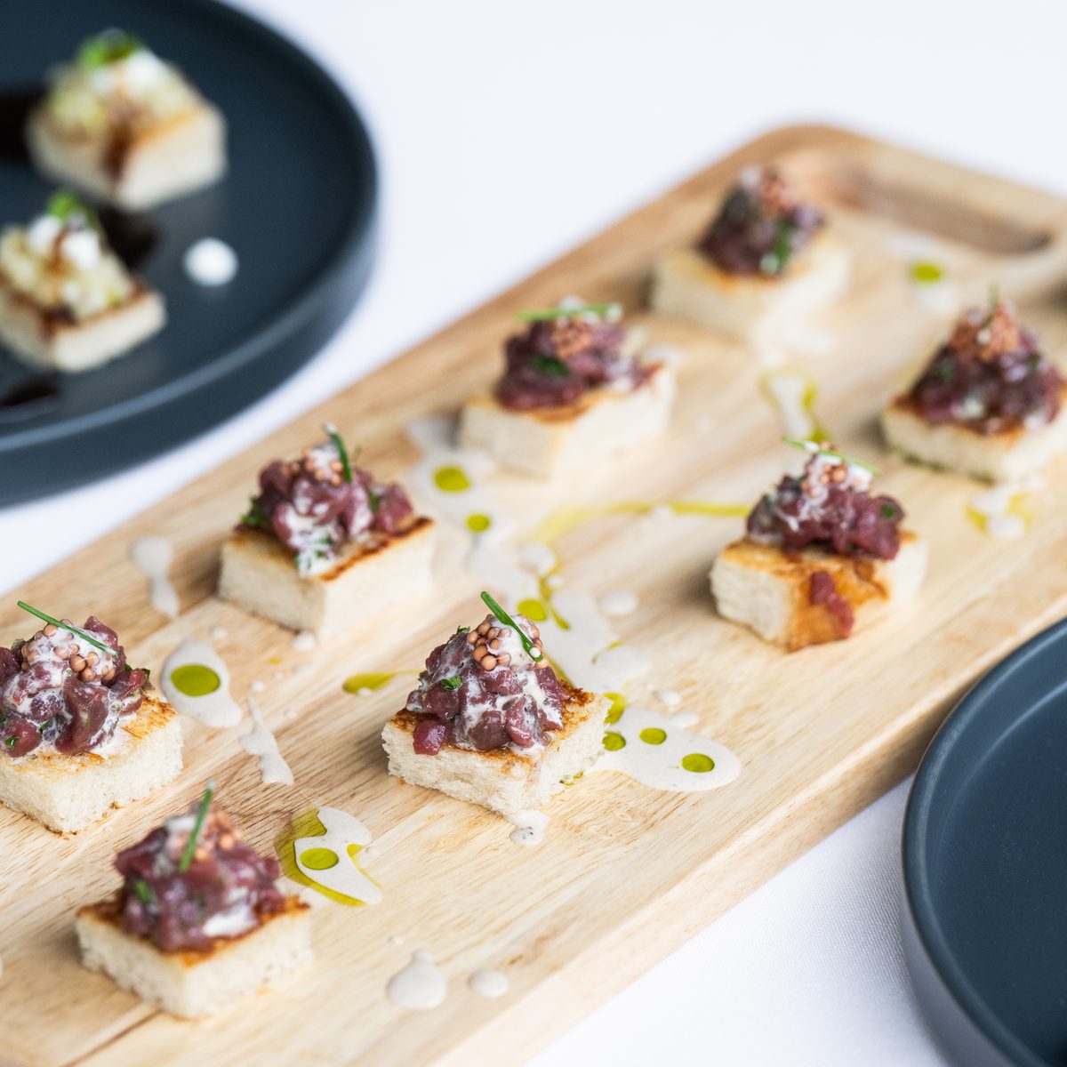 Wooden board of crostini appetizers for a family dinner at a Jackson Hole vacation rental