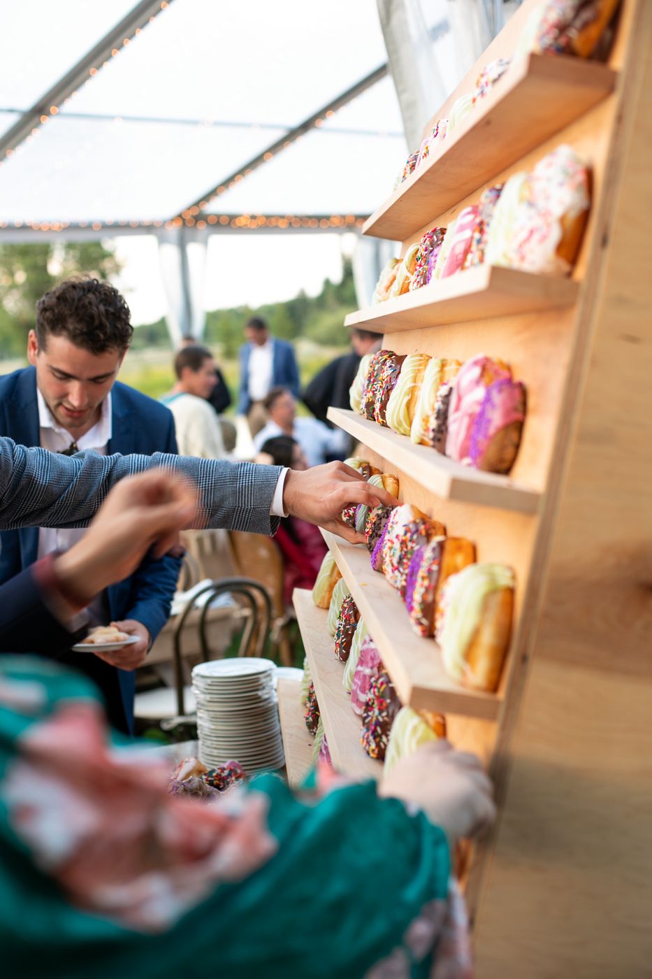 Wedding guests picking donuts from the Provisions donut wall