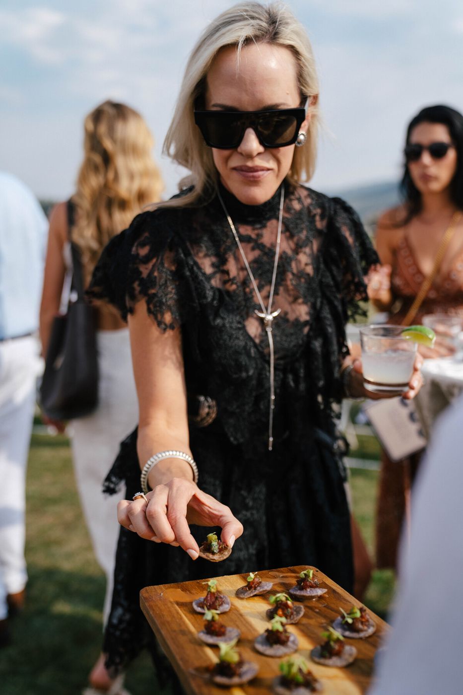 Guest taking an appetizer from a board at a wedding