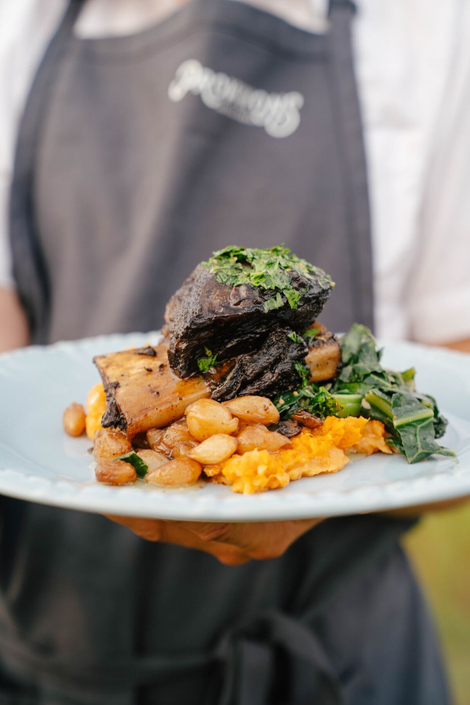 Plated short rib with white beans and greens