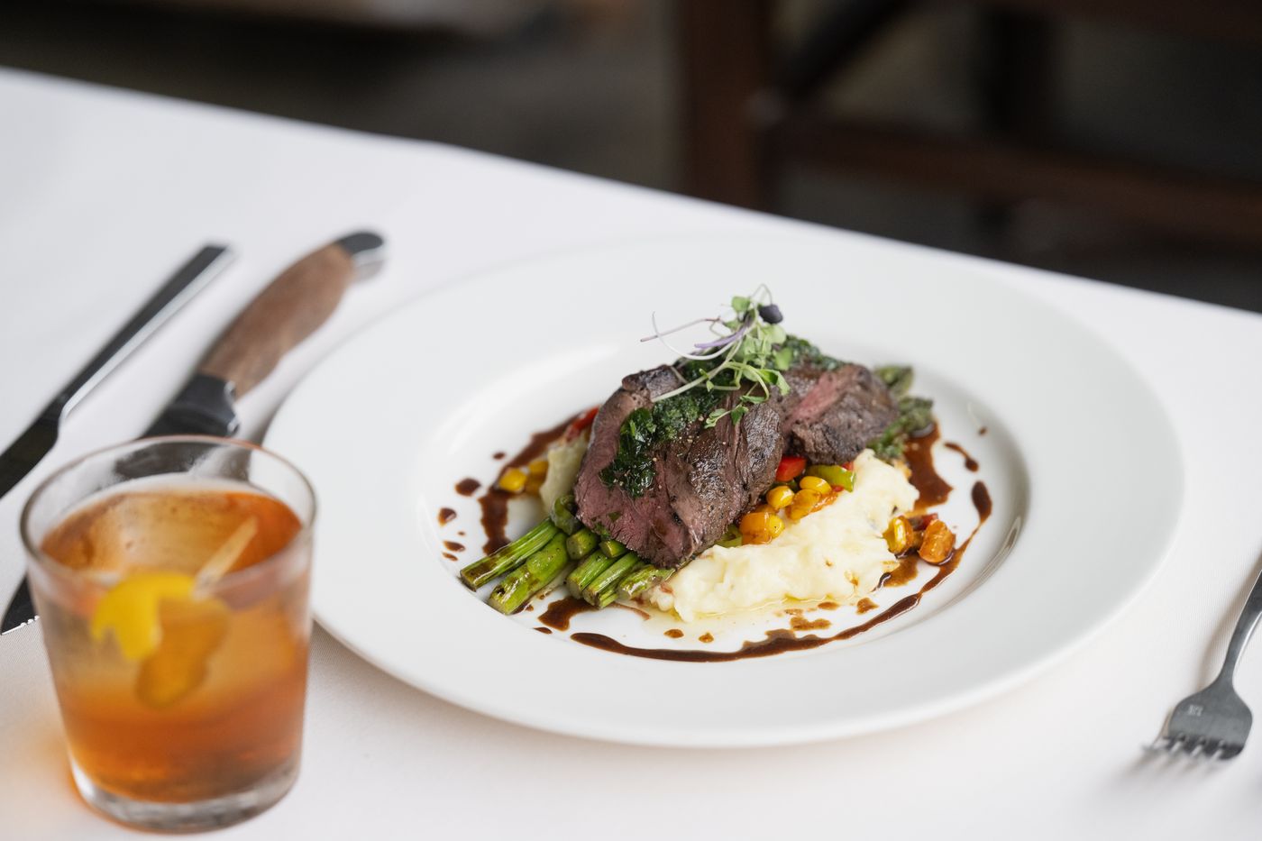 Plated steak dinner served with an old fashioned