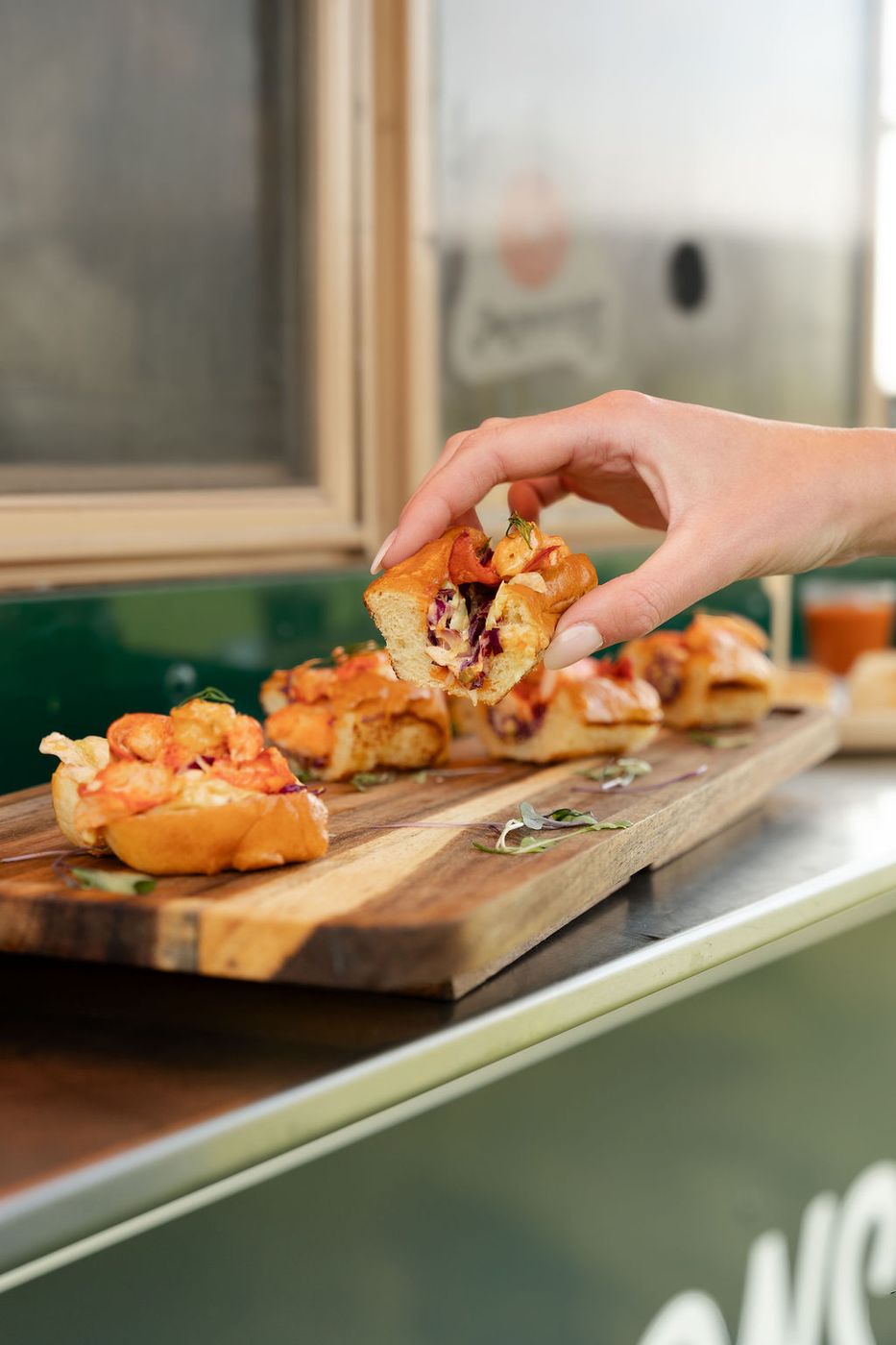 Guest taking a bite from a board on the truck counter