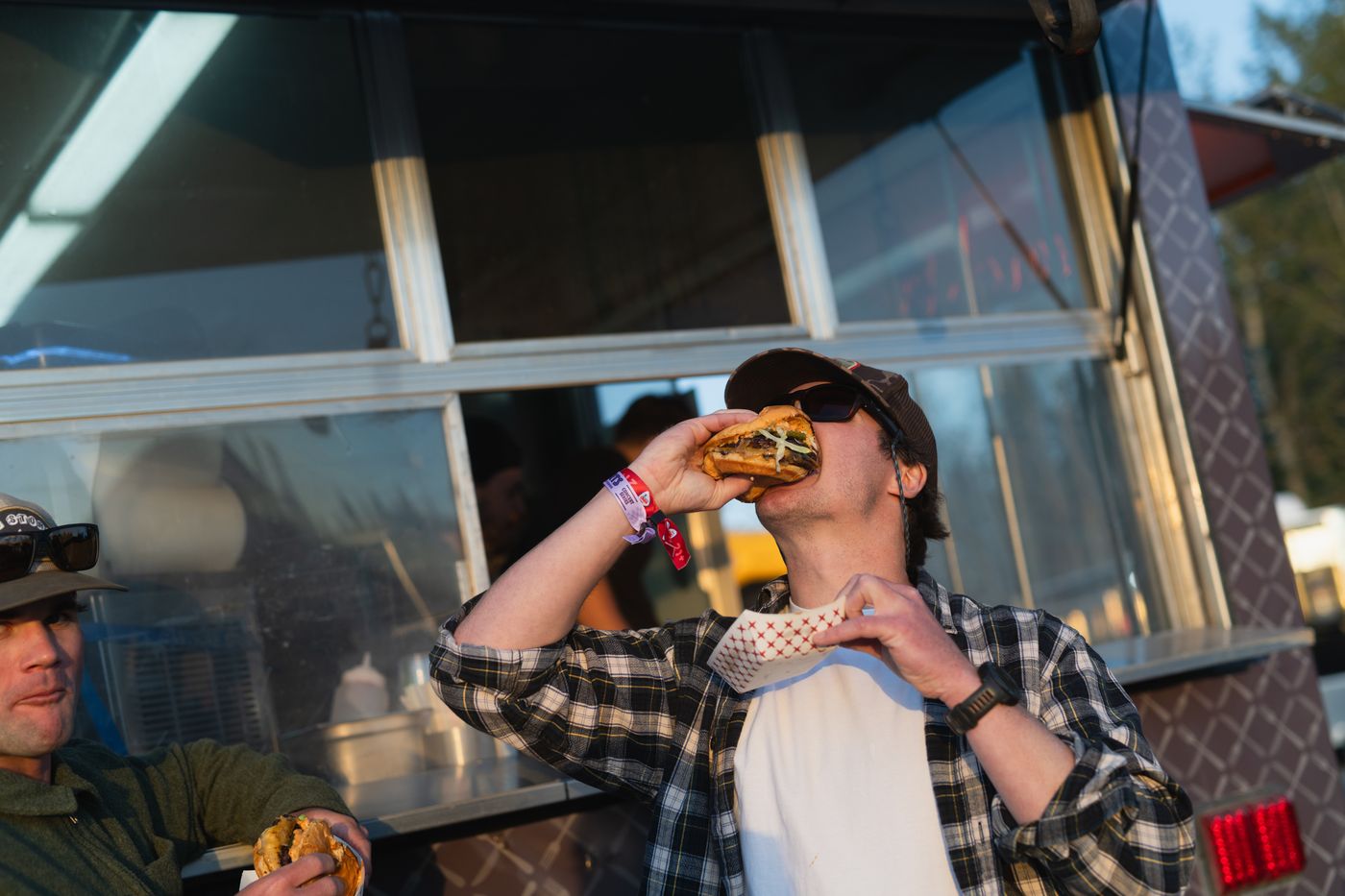 Concert guest biting into a burger