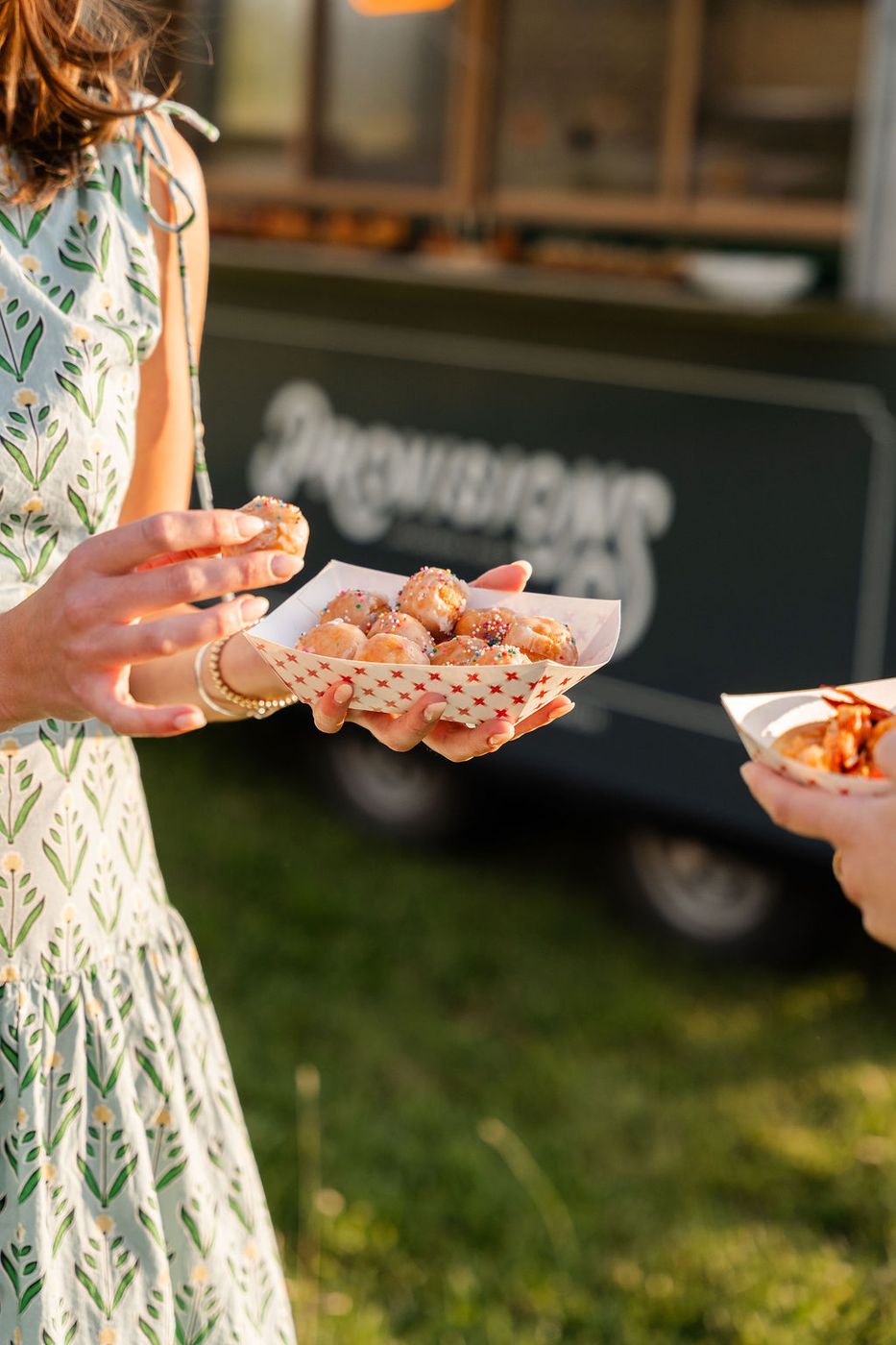 Guests holding food truck boats