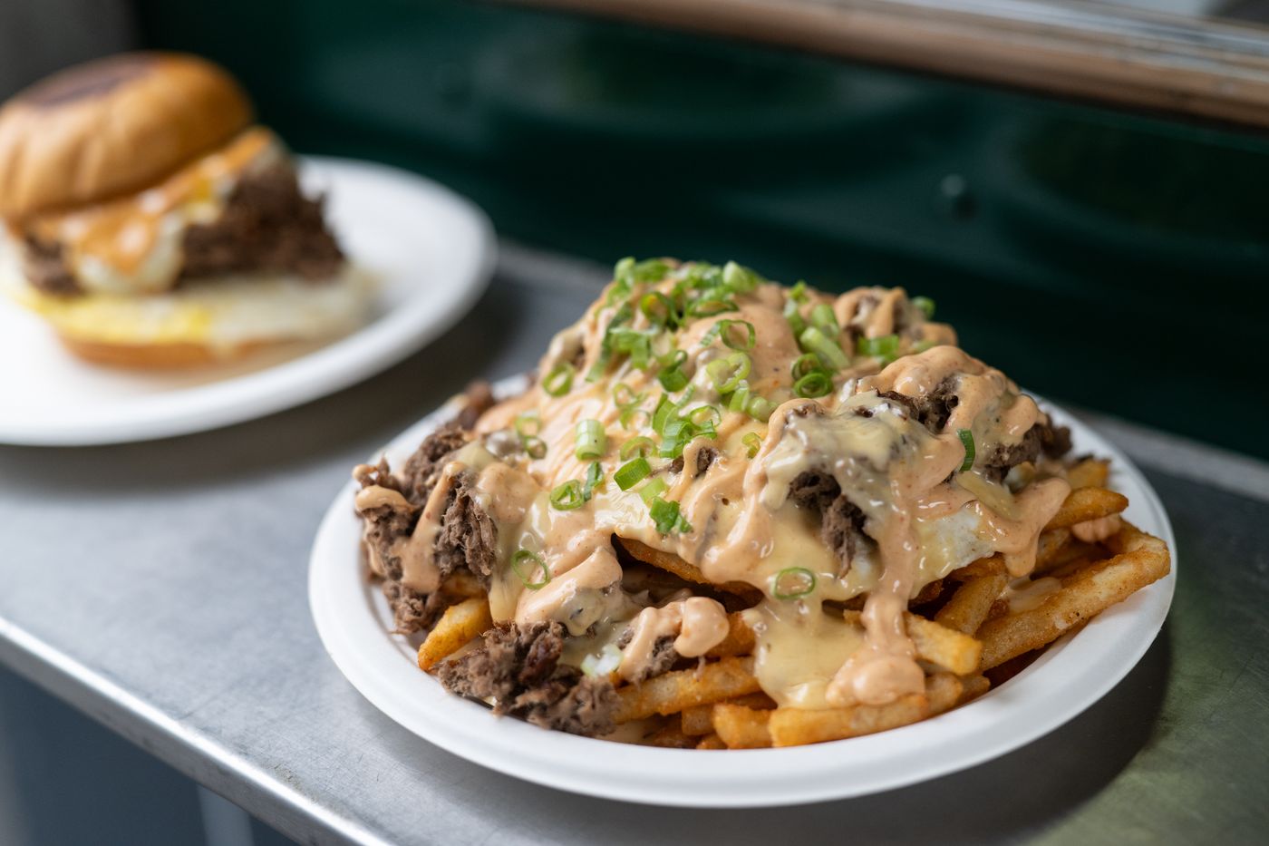 Loaded fries and a burger on the truck counter