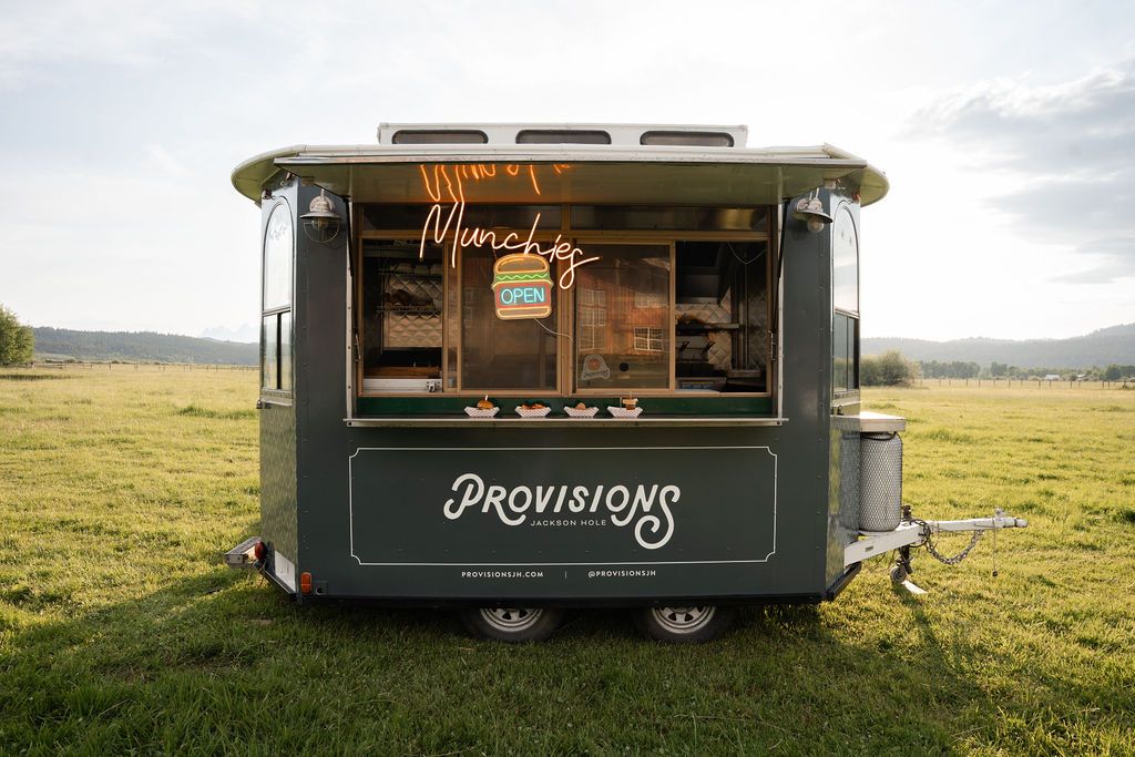 The Provisions vintage trolley food truck parked in a meadow in Jackson Hole