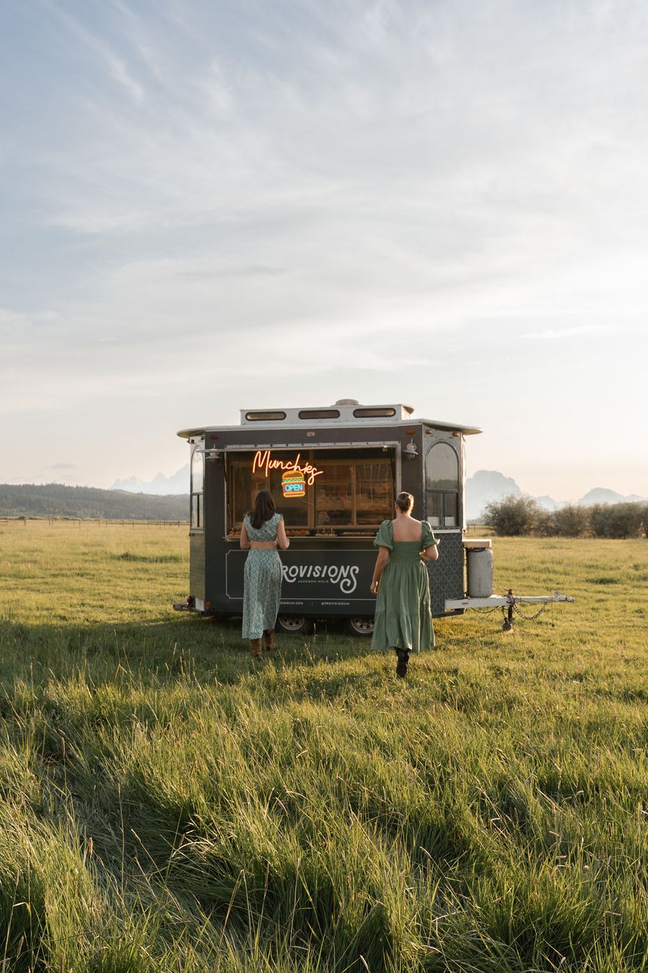 Guests walking to the food truck across a meadow