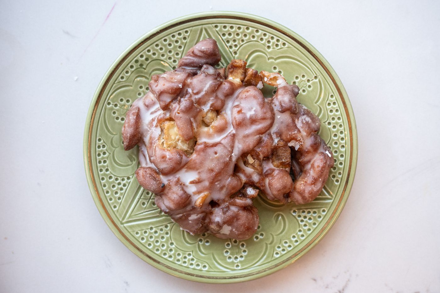 Apple fritter on a green plate