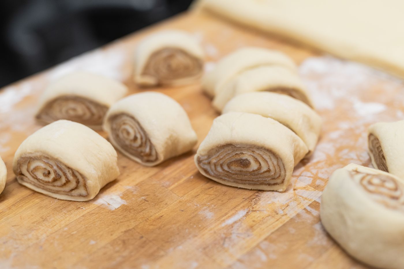 Cinnamon roll dough cut on a floured board