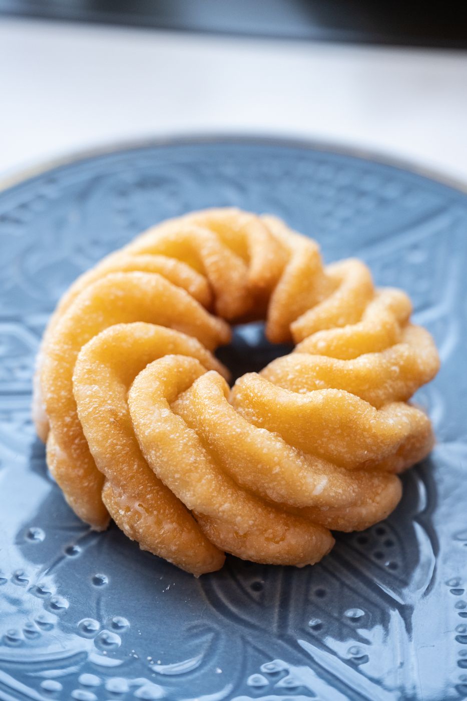 French cruller on a blue plate