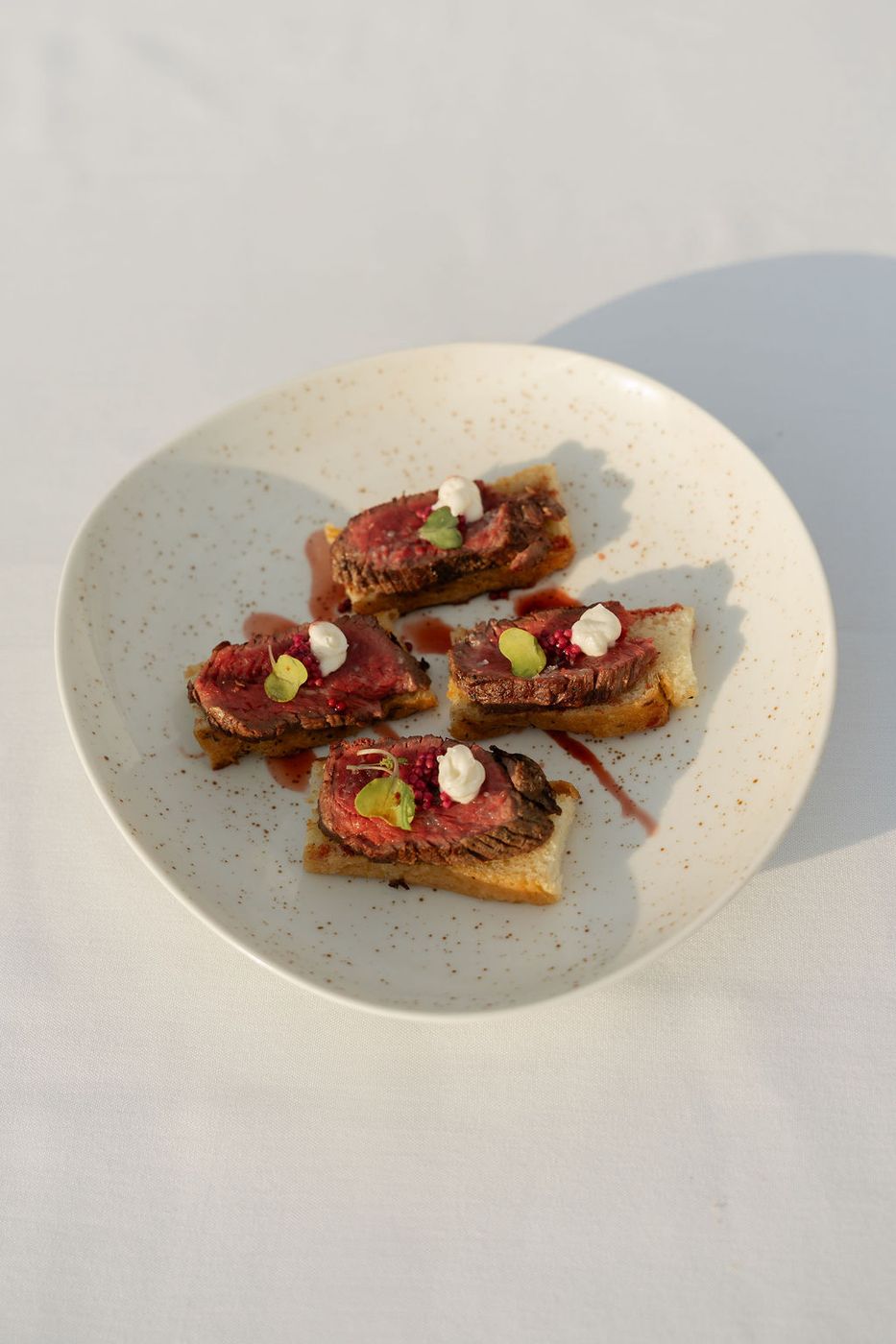 Beef crostini on a stoneware plate