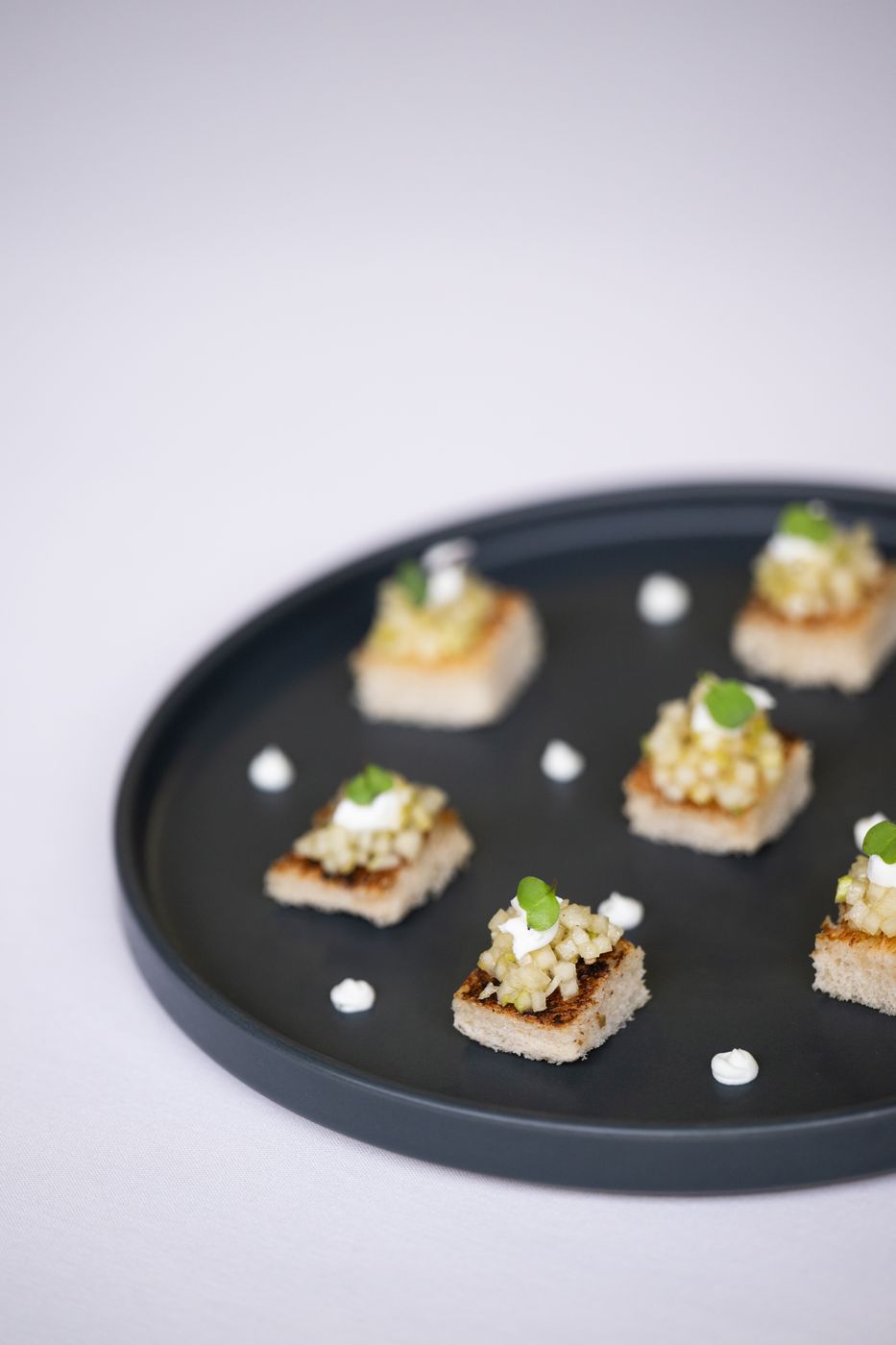 Canapés on a black plate