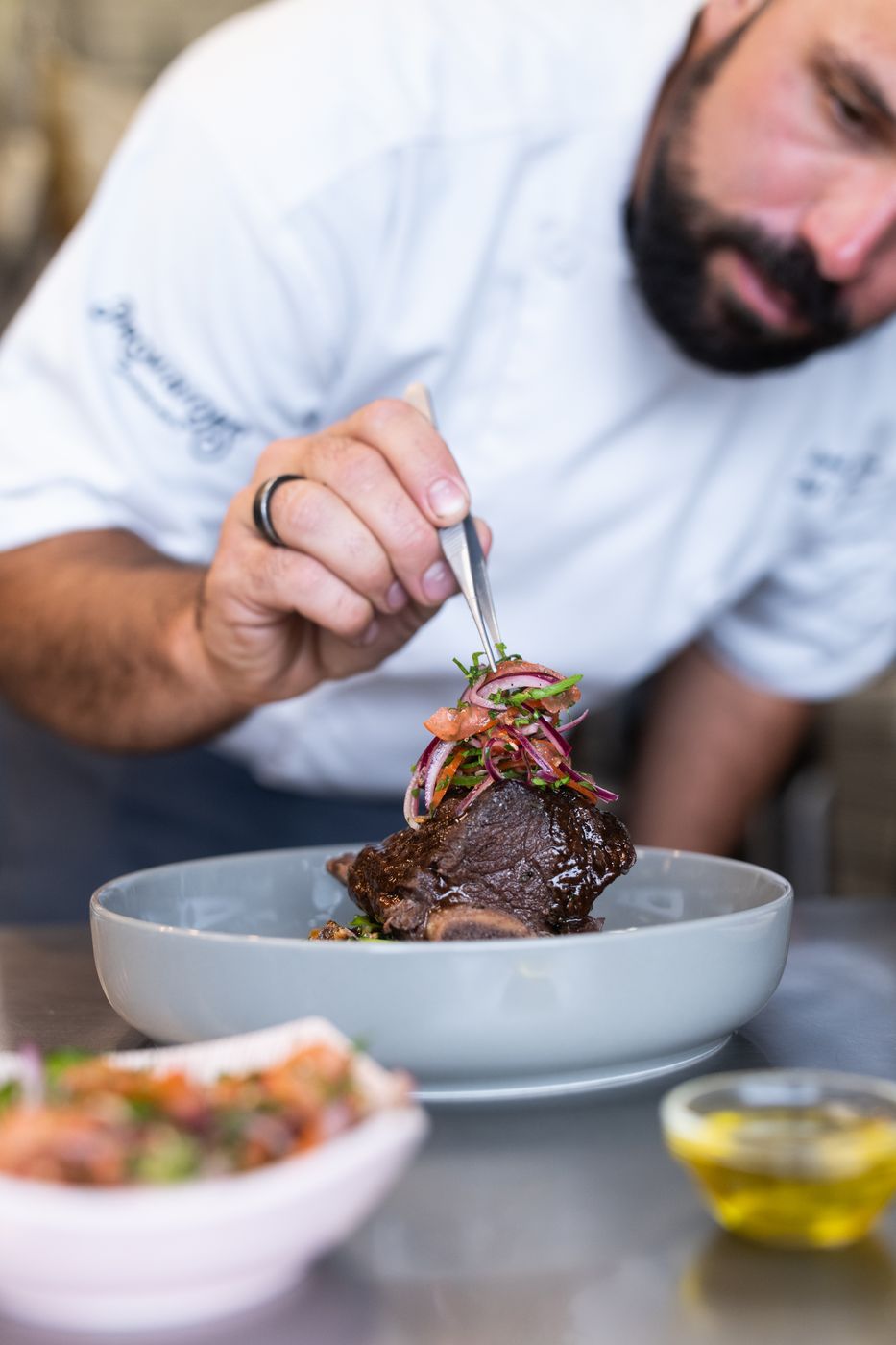 Chef garnishing braised short rib
