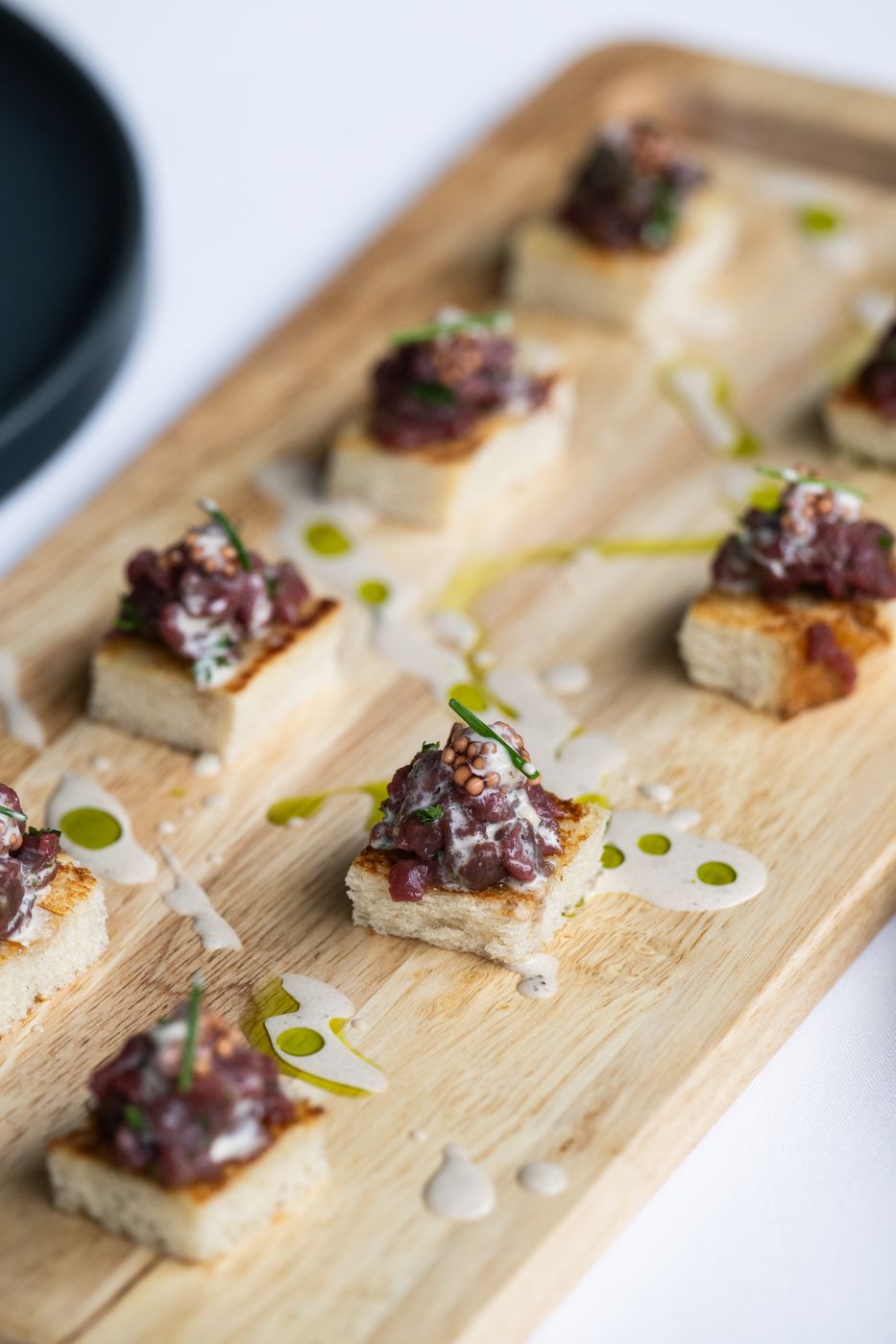 Crostini with olive oil on a wooden board