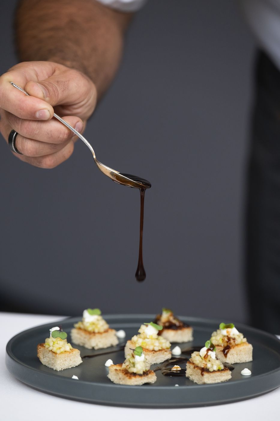 Sauce drizzled over a plate of canapés