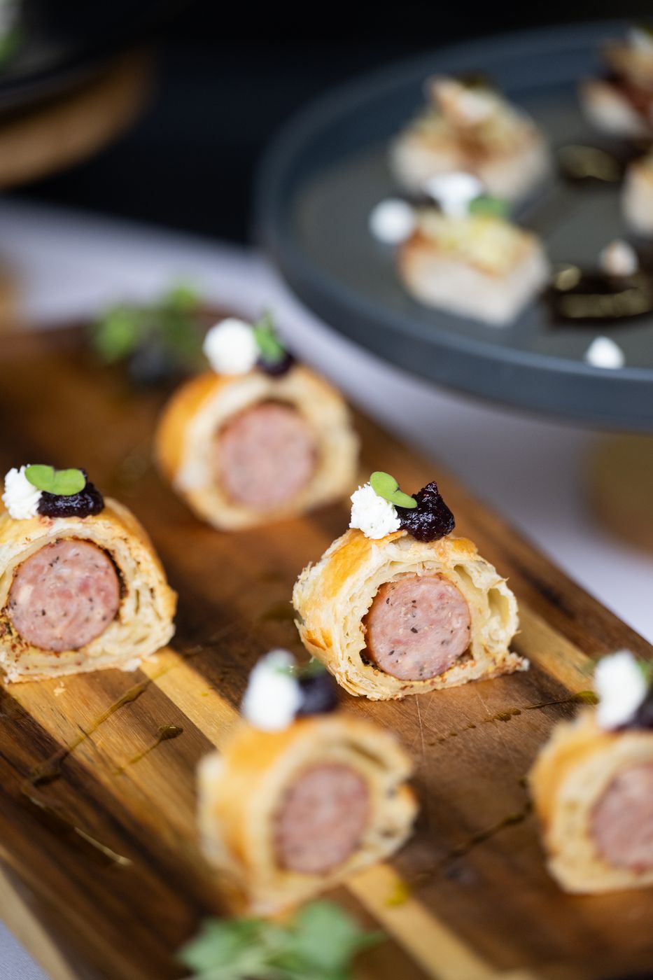 Mini sausage rolls on a wooden board