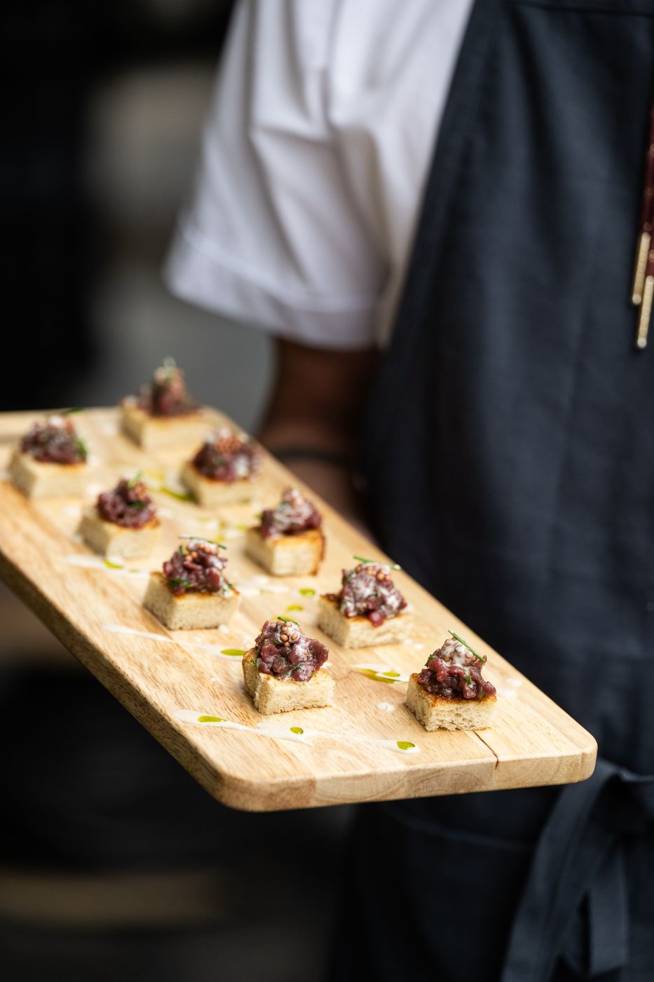 Server holding a board of crostini