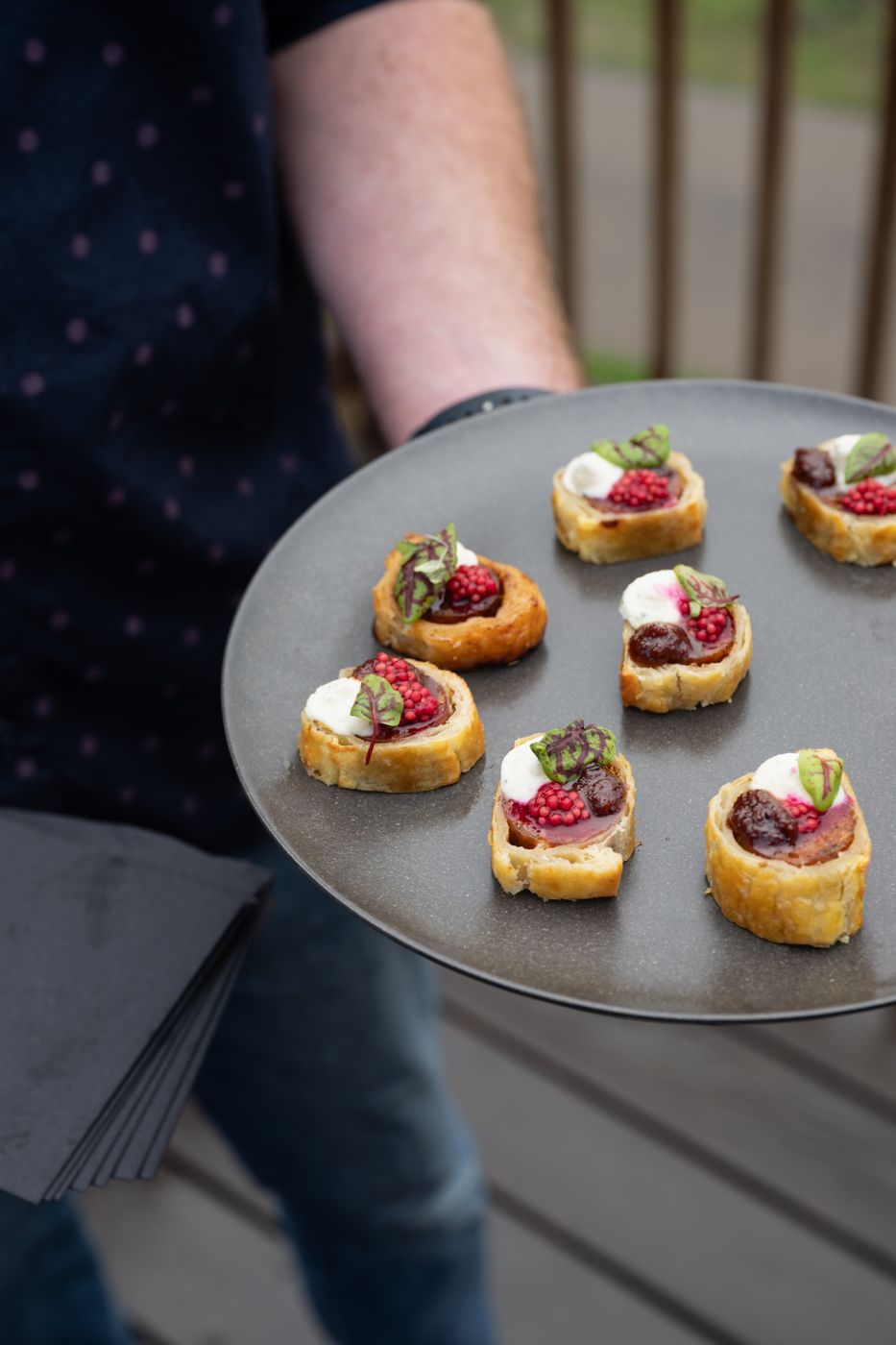Server holding a plate of bites