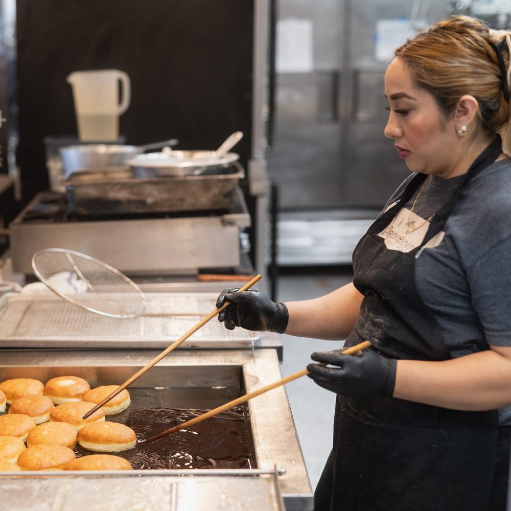 Provisions baker frying donuts in the Jackson Hole kitchen