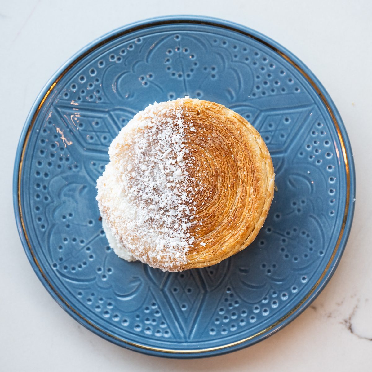 Sugared Provisions cruffin on a blue plate
